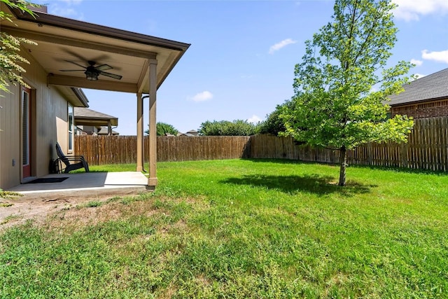 view of yard featuring a fenced backyard, a ceiling fan, and a patio