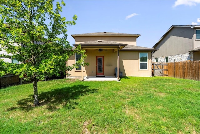 back of house featuring a patio area and a lawn