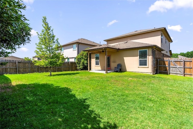 back of house featuring a yard and a patio