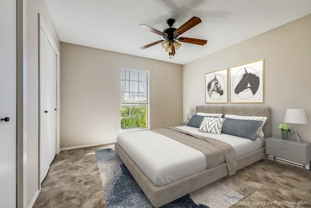 bedroom featuring ceiling fan, a textured ceiling, and a closet