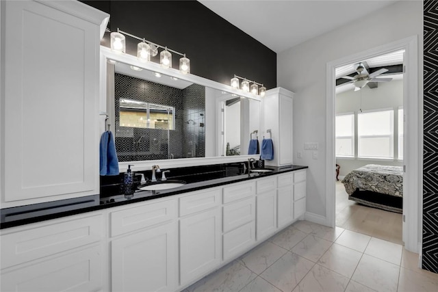 bathroom with a shower, vanity, and ceiling fan