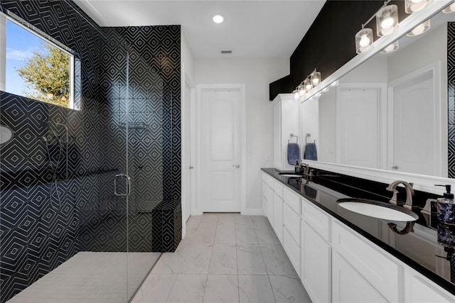 bathroom featuring vanity and tiled shower