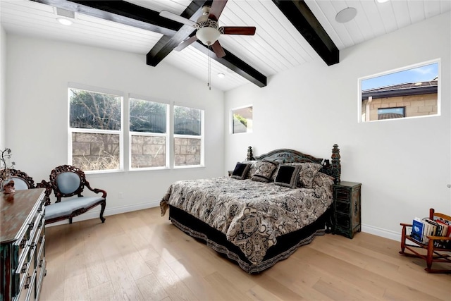 bedroom featuring light hardwood / wood-style flooring, lofted ceiling with beams, and ceiling fan