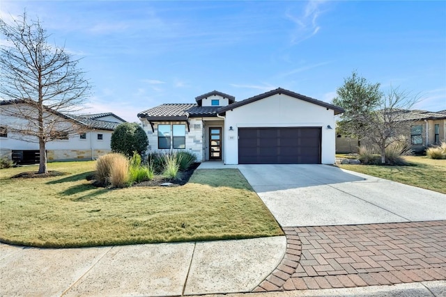 view of front of property with a garage and a front lawn