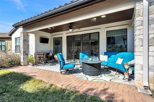 view of patio with an outdoor living space and ceiling fan