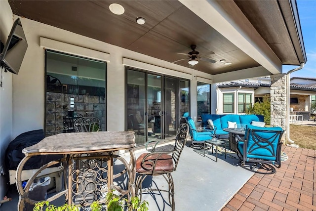 view of patio / terrace with an outdoor living space and ceiling fan