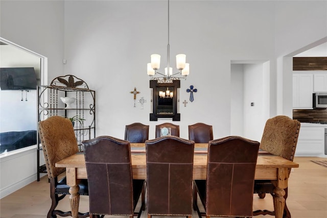 dining area featuring light hardwood / wood-style floors and a notable chandelier