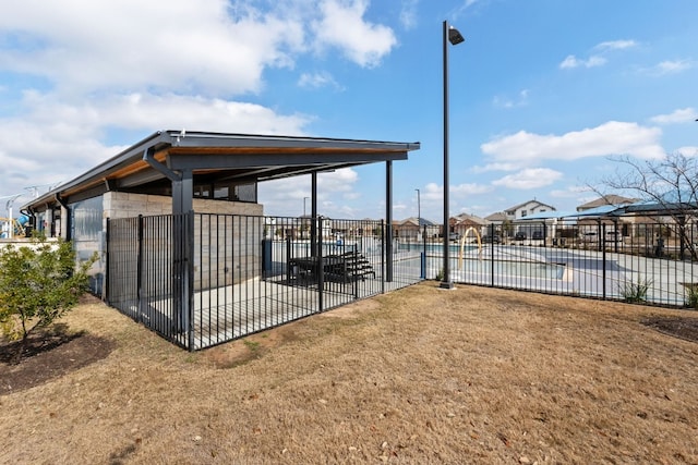 view of home's community with fence and a pool