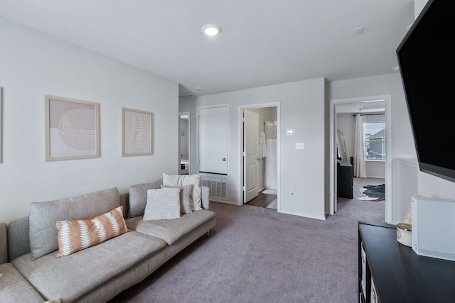 living area featuring carpet floors and baseboards