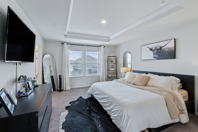 bedroom featuring a raised ceiling, light carpet, and baseboards