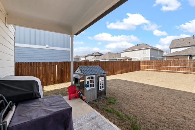 view of patio / terrace featuring a residential view, a fenced backyard, and area for grilling