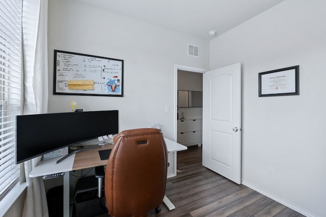 office with dark wood finished floors, visible vents, and baseboards