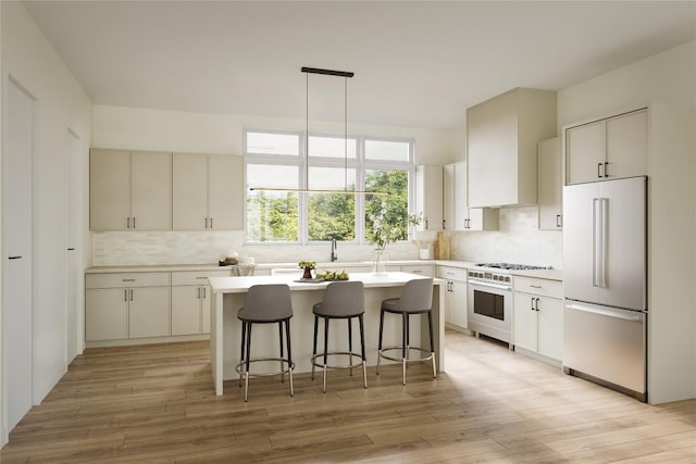 kitchen featuring wall chimney exhaust hood, high quality fridge, a kitchen island, oven, and decorative backsplash