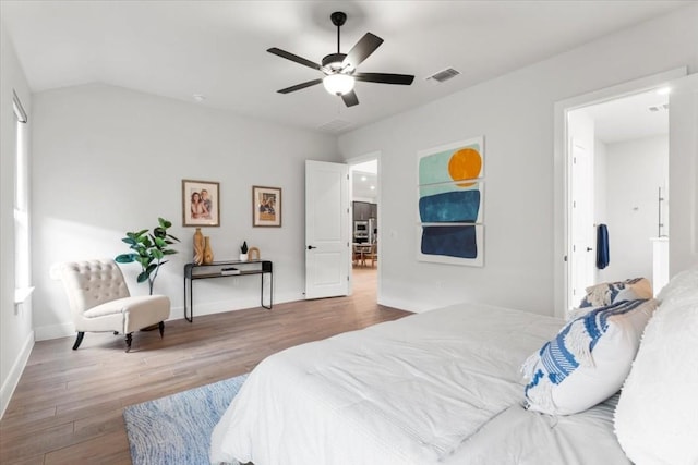 bedroom with vaulted ceiling, ceiling fan, and hardwood / wood-style floors