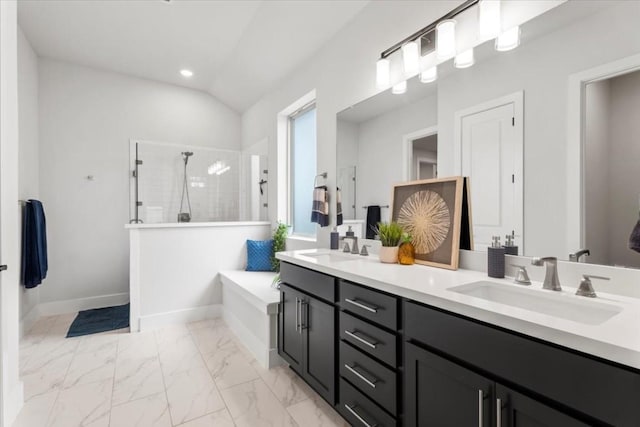 bathroom with vanity, separate shower and tub, and vaulted ceiling