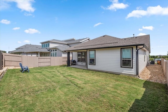 rear view of property featuring central AC, a patio area, and a lawn