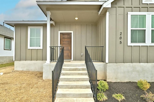 view of exterior entry featuring board and batten siding