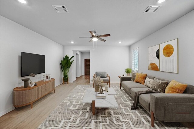 living room featuring ceiling fan and light hardwood / wood-style flooring