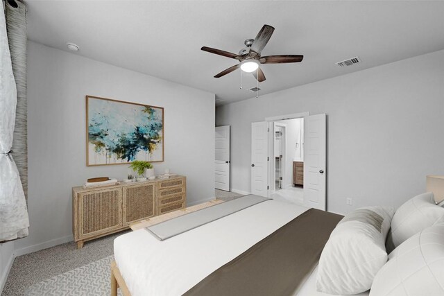 carpeted bedroom featuring connected bathroom and ceiling fan