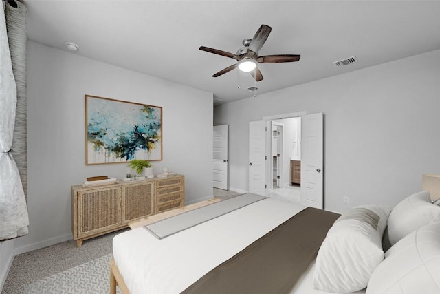 carpeted bedroom featuring ceiling fan and ensuite bath