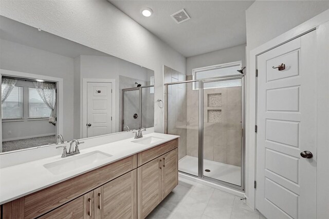 bathroom with walk in shower, plenty of natural light, and vanity