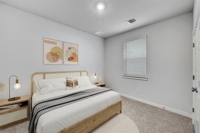bedroom featuring visible vents, baseboards, and carpet