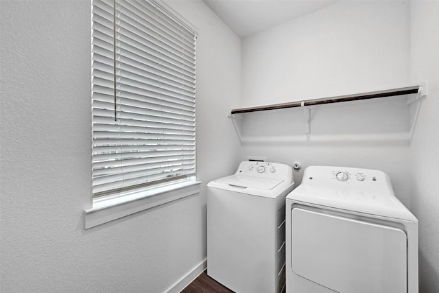 laundry room with dark wood-type flooring and washer and dryer