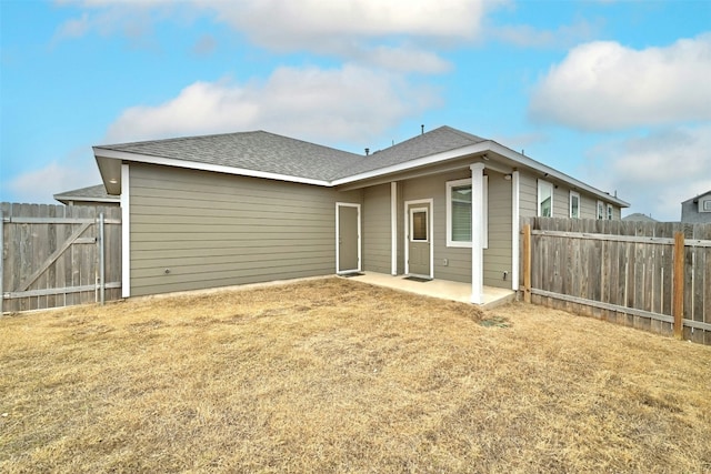 rear view of house featuring a patio and a lawn