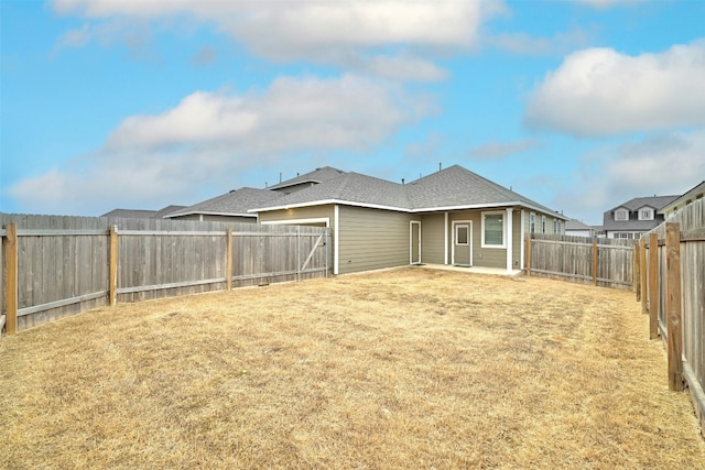 back of property featuring a lawn