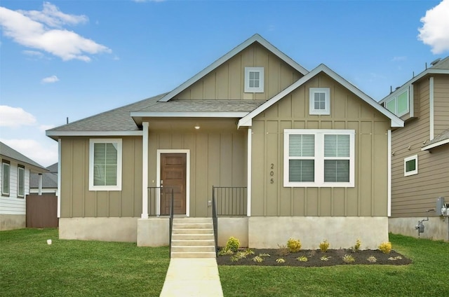 205 Ashby Dr, Hutto, TX 78634 - bungalow-style house featuring board and batten siding, roof with shingles, and a front lawn