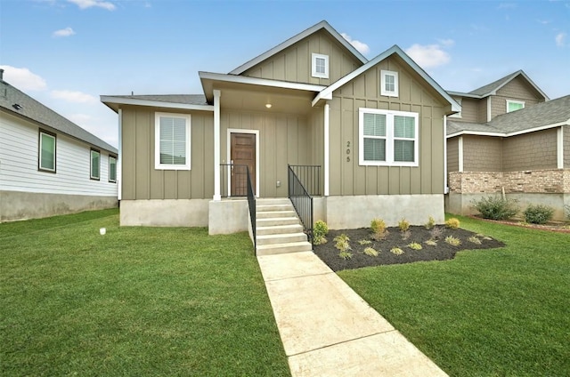 205 Ashby Dr, Hutto, TX 78634 - view of front facade featuring board and batten siding and a front lawn