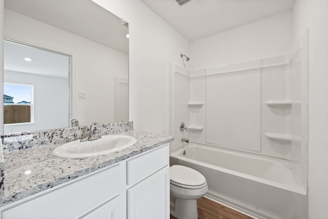 full bathroom featuring toilet, vanity, bathtub / shower combination, and hardwood / wood-style floors