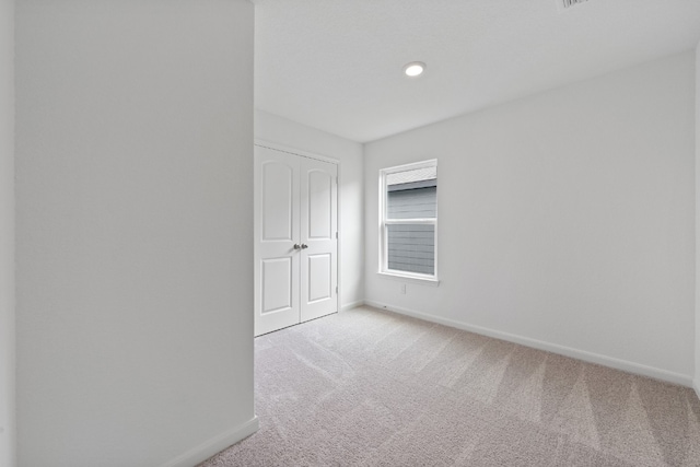 empty room with light colored carpet