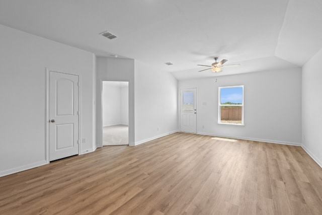 empty room with ceiling fan and light hardwood / wood-style floors