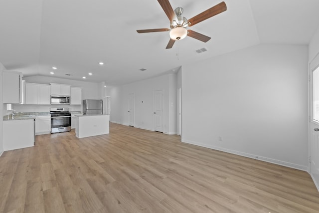 unfurnished living room with ceiling fan, lofted ceiling, sink, and light wood-type flooring