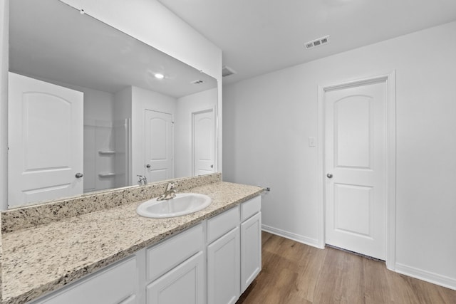 bathroom with hardwood / wood-style flooring and vanity