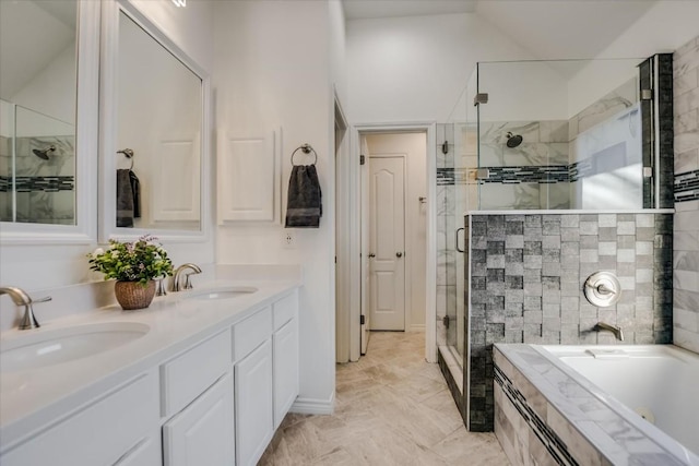 bathroom featuring vanity and shower with separate bathtub