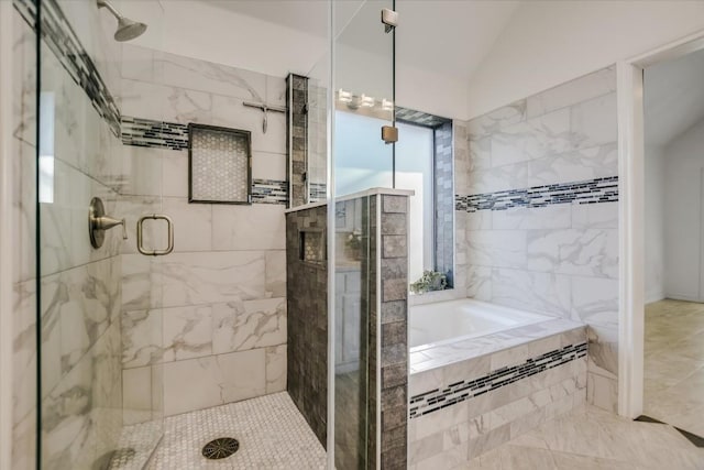 bathroom featuring separate shower and tub and vaulted ceiling