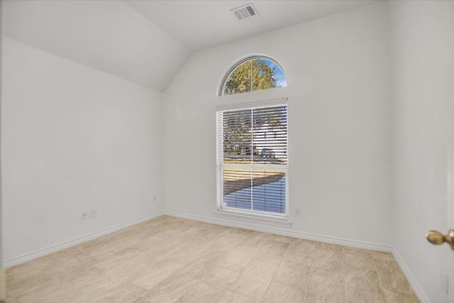 empty room with lofted ceiling