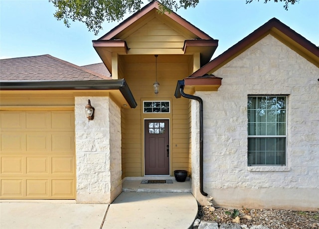 view of exterior entry featuring a garage