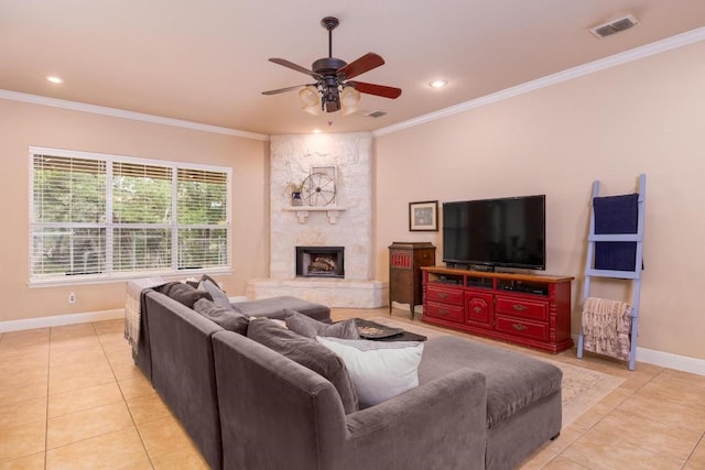 living room with light tile patterned floors, a fireplace, ornamental molding, and ceiling fan