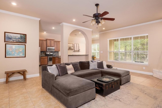 tiled living room with crown molding and ceiling fan