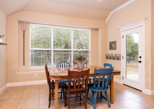 tiled dining room featuring vaulted ceiling and a wealth of natural light