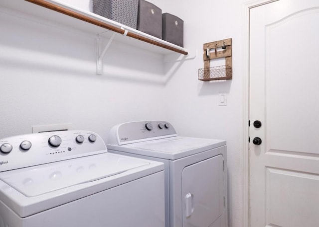 clothes washing area with washing machine and dryer