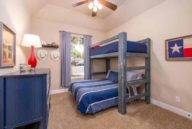 bedroom featuring a tray ceiling, ceiling fan, and carpet