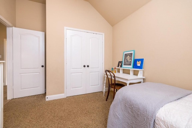 bedroom with vaulted ceiling, a closet, and carpet flooring