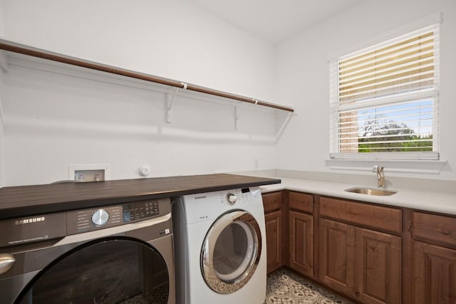 washroom featuring sink, cabinets, and washer and dryer