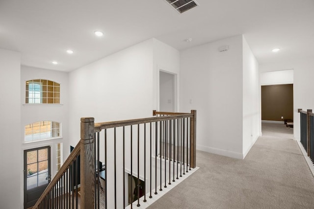 hallway featuring light colored carpet