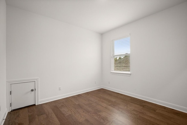 unfurnished room with dark hardwood / wood-style floors