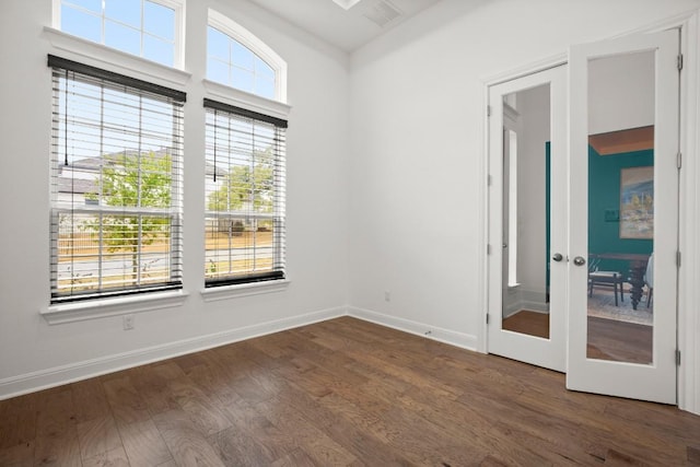 empty room with dark hardwood / wood-style flooring